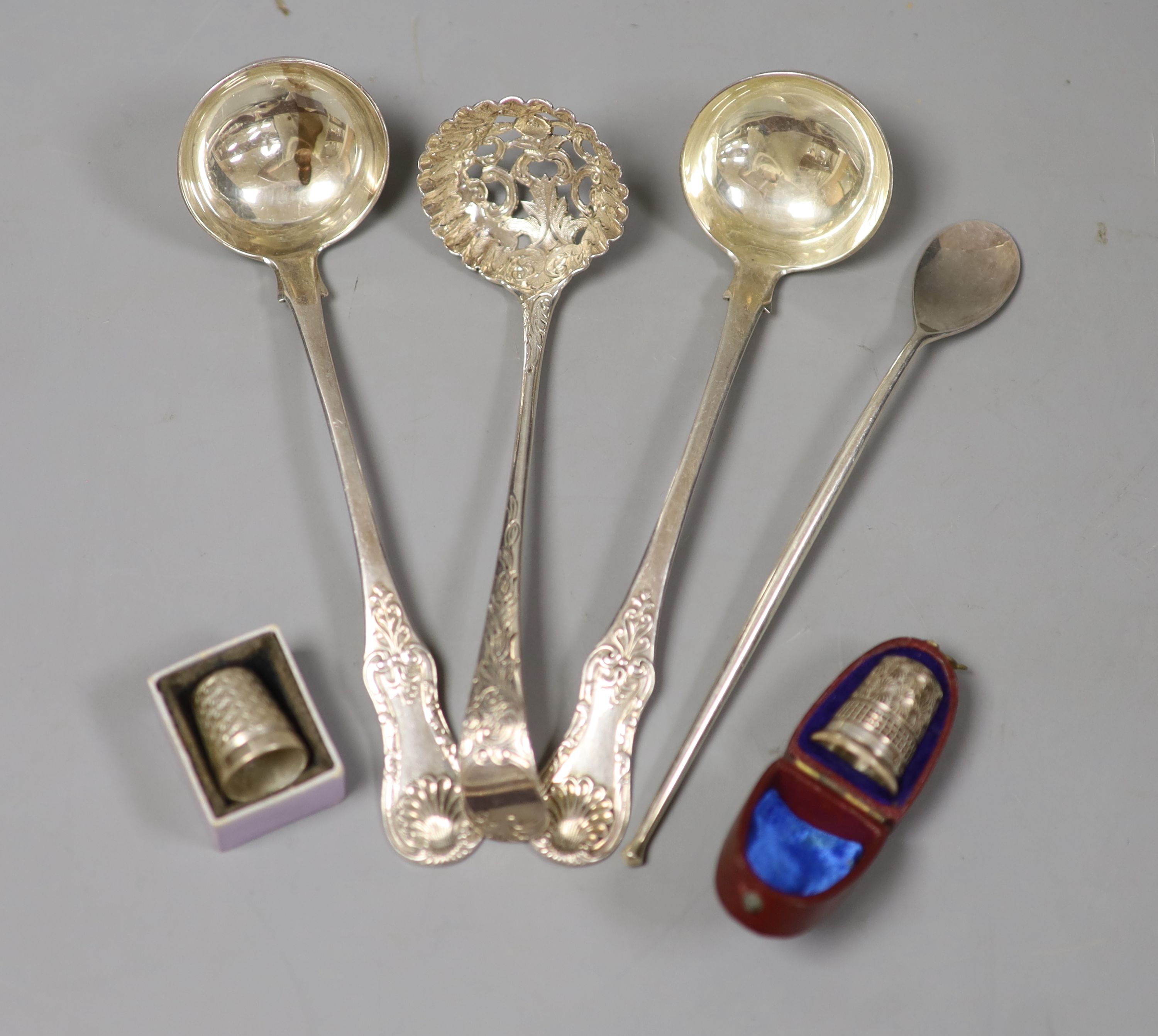 A pair of William IV Scottish silver Queen's pattern sauce ladles, Glasgow, 1930, a Georgian silver sifter spoon, one other spoon and two thimbles, including silver Charles Horner.